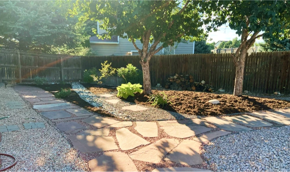 Mulch and rock refresh done in a backyard.